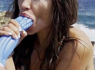 Hot pornstar Monika Foxxx masturbates and fucks herself with a big octopus dildo on a reef beach
