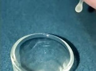 Closeup dripping cum in shot glass slo-mo