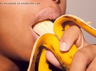 Naughty ebony with pouty lips playing with a banana