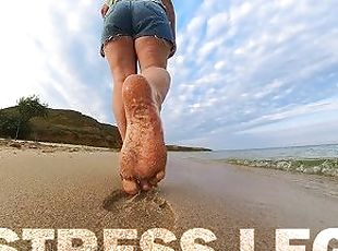 Barefoot Girl Walks Over The Summer Seashore